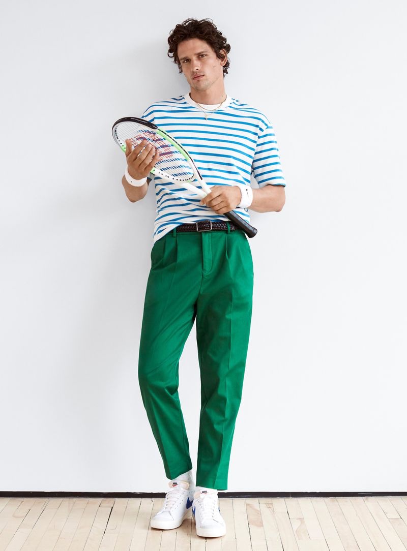 Mixing bright colors, Simon Nessman rocks a striped t-shirt with green pleated trousers from Simons.