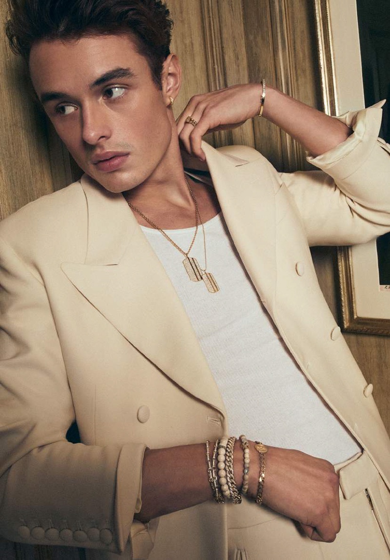 A chic vision, Duke Maxwell wears gold and diamond dog tag necklaces with other accessories from Sydney Evan.