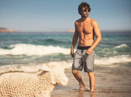 Model James Crabtree hits the beach in boardshorts from the Vilebrequin x The Woolmark Company collection.