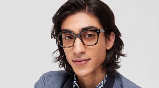 Warby Parker Channels Summertime Bliss with New Eyewear Collection Adarsh Jaikarran charms in a pair of Warby Parker's Winston glasses in Black Oak Tortoise.