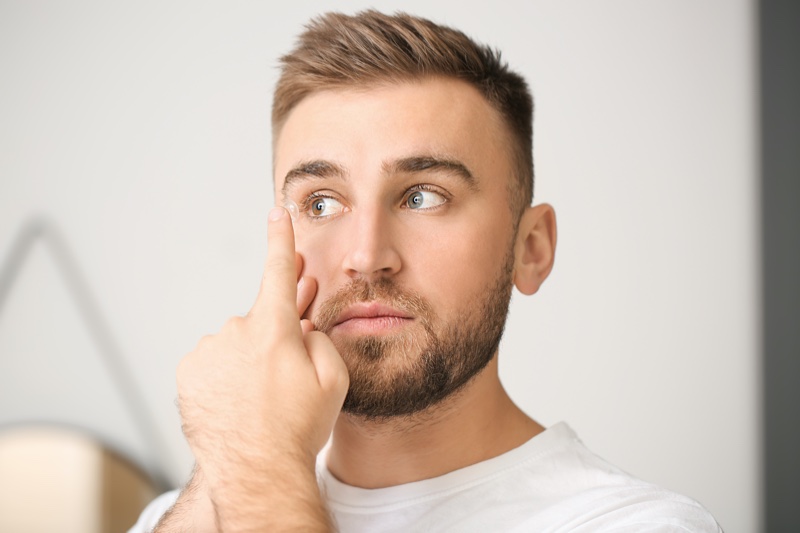 Young Man Putting Contact Lens Eye