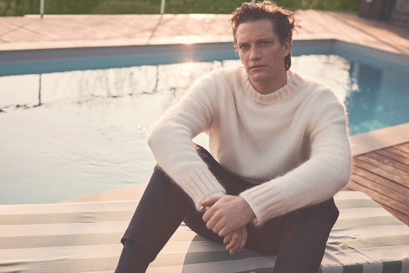 Florian Van Bael wears a Jil Sander sweater and trousers from Luisaviaroma.