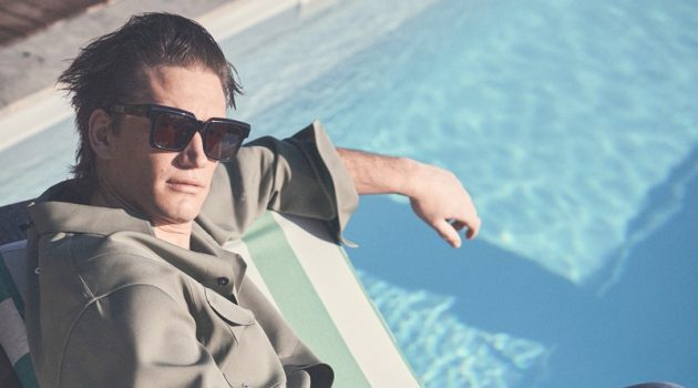 Relaxing poolside, Florian Van Bael sports a Jil Sander shirt with Loewe jeans and Retrosuperfuture sunglasses.