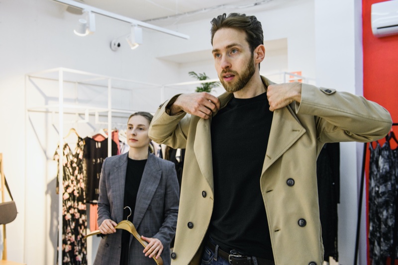 Guy Trying Jacket On Store