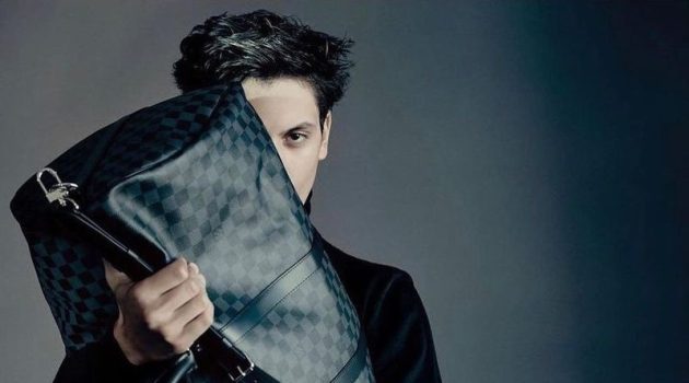 Model Takfarines Bengana pictured with Louis Vuitton's keepall bag in its Damier print.