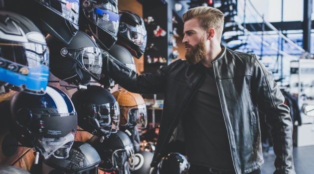 How to Choose a Helmet that Suits Your Style Man Shopping for Helmet Leather Jacket
