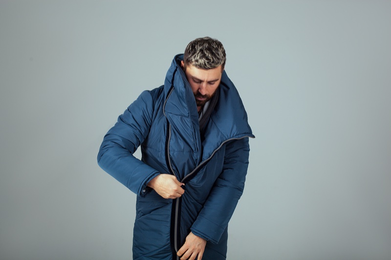 Man Zipping Blue Coat