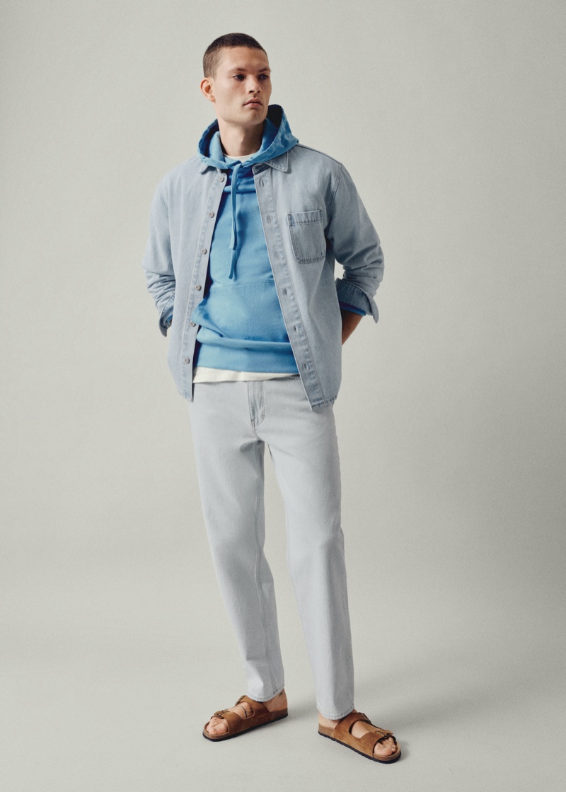 William Los wears light wash denim from Mango Man.