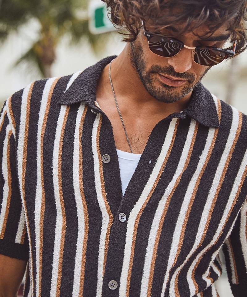 Model Marlon Teixeira wears Todd Snyder's cotton boucle placket vertical stripe sweater polo in black. » Marlon Teixeira Cruises Into Summer with Fresh Todd Snyder Styles Model Marlon Teixeira wears Todd Snyder's cotton boucle placket vertical stripe sweater polo in black.