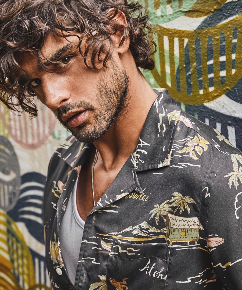 Brazilian model Marlon Teixeira rocks Todd Snyder's Aloha print short-sleeve camp collar shirt in black.