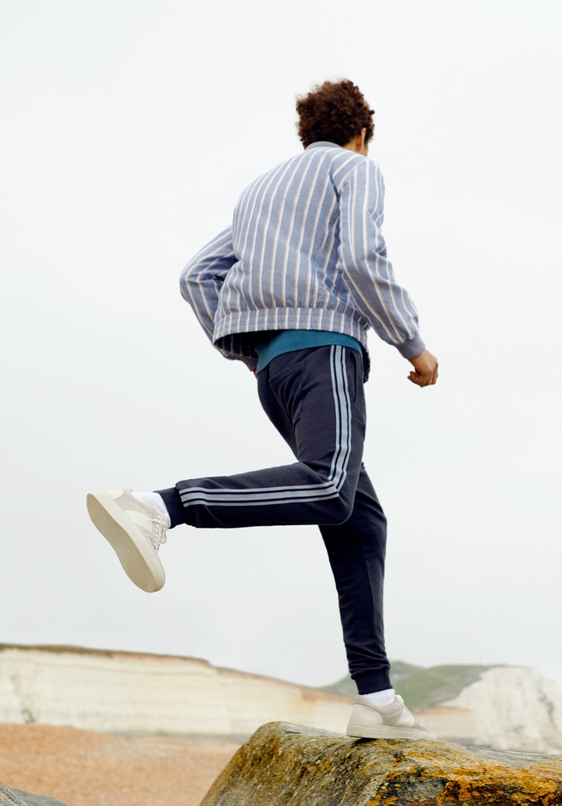 On the move, Jackson Hale dons a Mr P. striped cotton and linen-blend bomber jacket with an organic cotton-jersey t-shirt.
