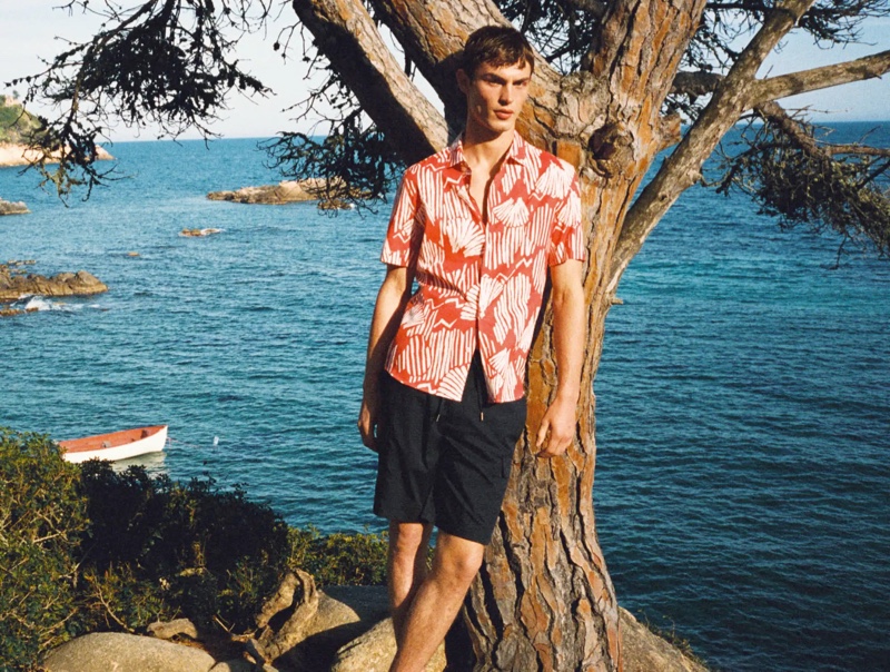 Kit Butler wears a short-sleeve red print shirt with drawstring shorts from Mango Man.