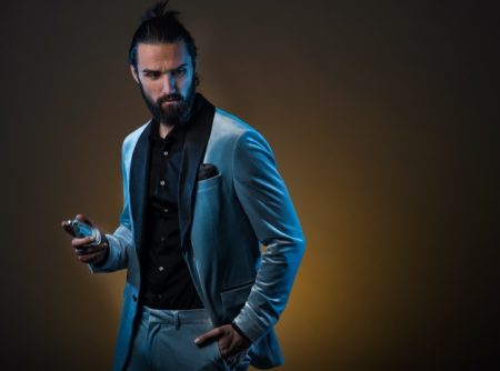 Male Model Blue Suit Holding Fragrance Bottle