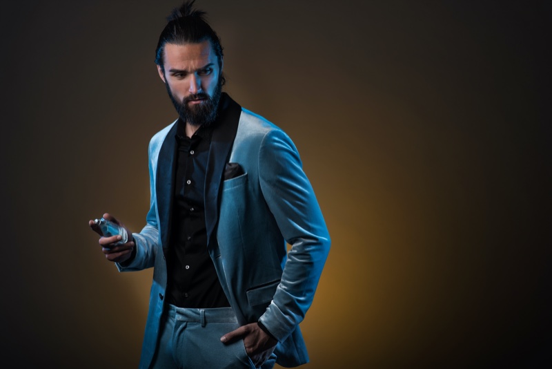Male Model Blue Suit Holding Fragrance Bottle