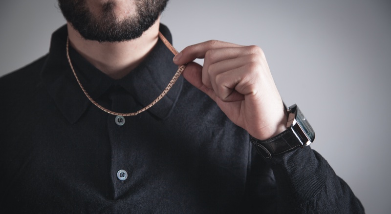 Man Holding Gold Chain Necklace