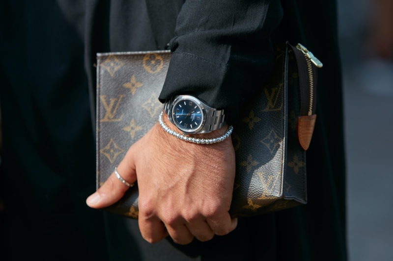 Man Wearing Rolex Carrying Louis Vuitton Bag