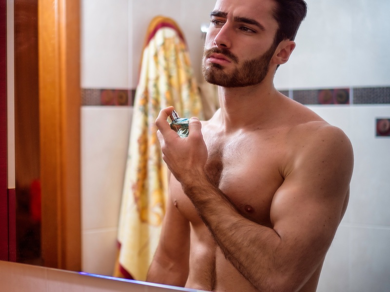 Shirtless Male Spraying Cologne Bathroom