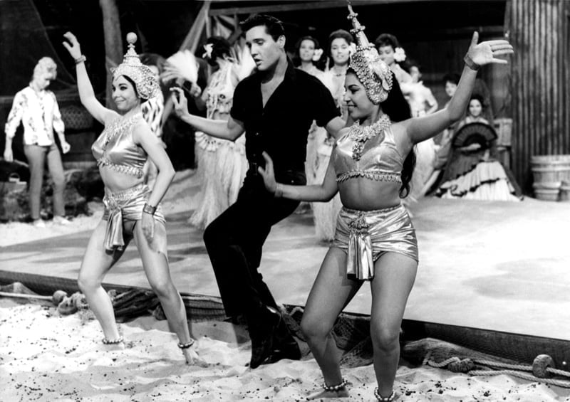 Elvis Presley in a monochrome black camp-collar shirt and trousers in the 1962 film Girls Girls Girls