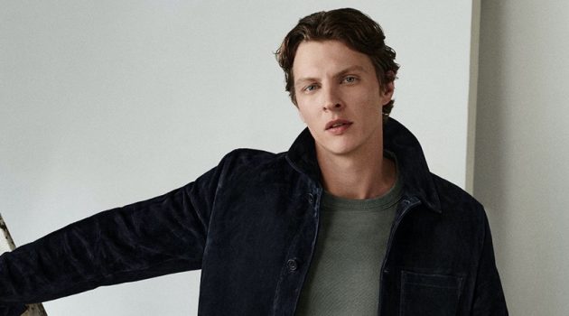 Tim Schuhmacher Models Fall Arrivals from COS Embracing COS's fall style, Tim Schuhmacher models a suede jacket with a heavyweight sweater and light-colored jeans.