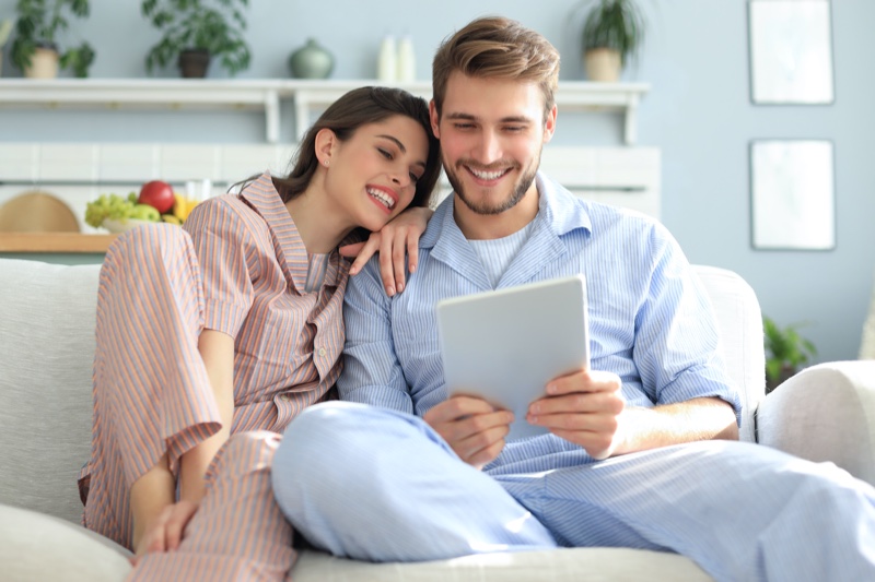 Couple Wearing Pajama Sets Couch