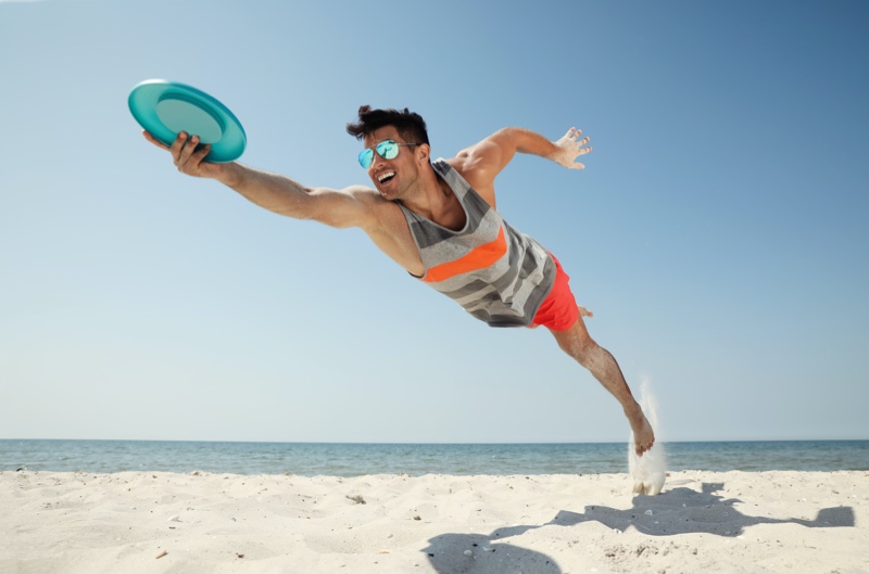 Man Catching Frisbee Beach