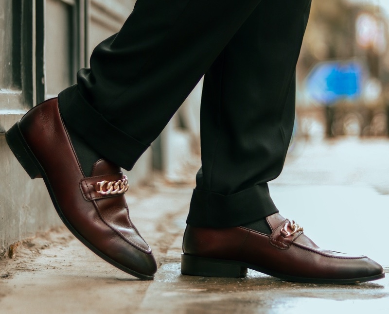 man wearing brown loafers gold chain detail