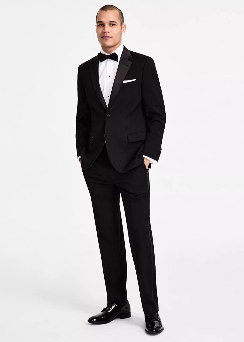 Black tuxedo with a white tuxedo shirt, black bow-tie, and white pocket square from Nautica