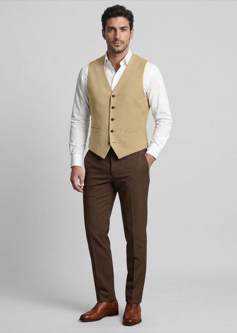 A smart casual tan waistcoat outfit with a white shirt, brown trousers, and tan brogues from Studio Suits