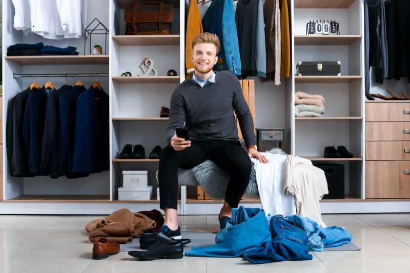 Smiling Man Organizing Closet