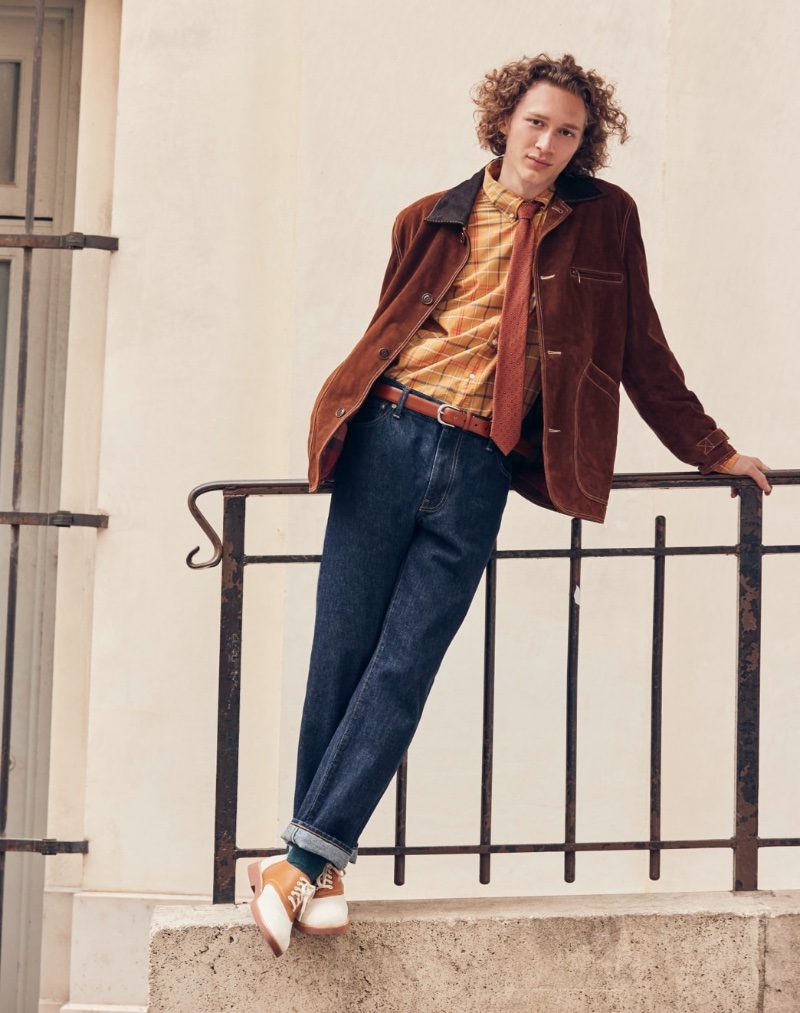 Taking to the streets of Paris, Mathis Durand models an Italian suede Barn Jacket, Secret Wash cotton poplin shirt, and a foulard wool tie with classic straight-fit jeans in resin wash from J.Crew. Saddle shoes complete his fall ensemble. 