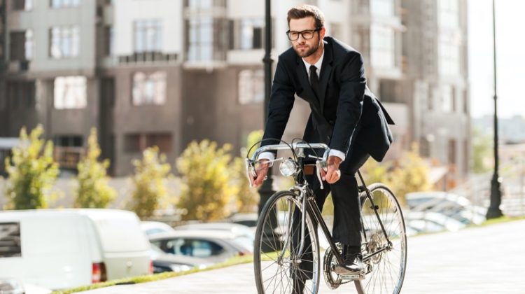 Male Model Wearing Suit Using Bicycle