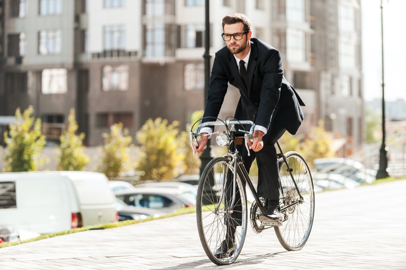 Male Model Wearing Suit Using Bicycle