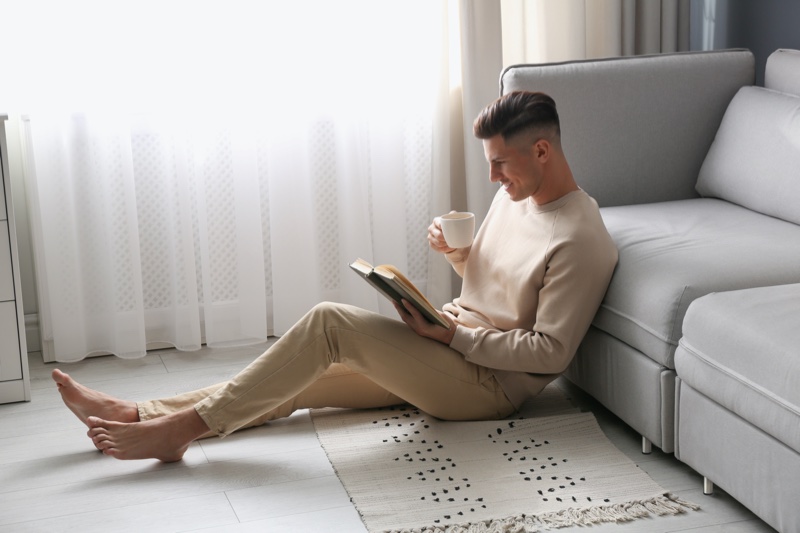 Man Drinking Tea Reading Book Couch