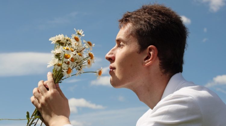 Man Smelling Flowers