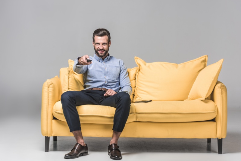 Man Watching TV Stylish Yellow Couch