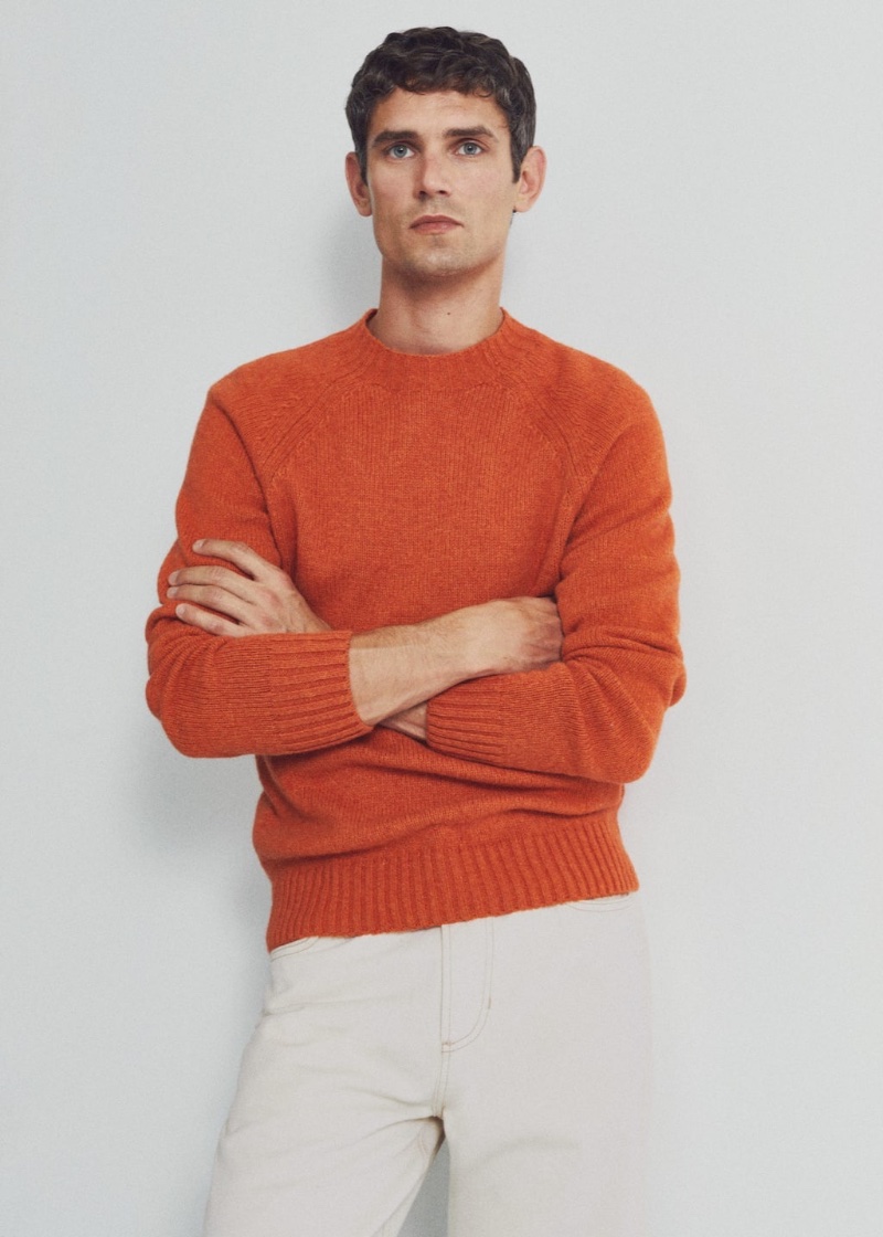 French model Arthur Gosse stands out in Mango Man's orange wool sweater.