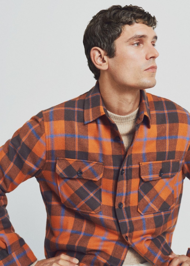 Embracing autumnal tones, Arthur Gosse models a Mango Man orange check cotton overshirt.