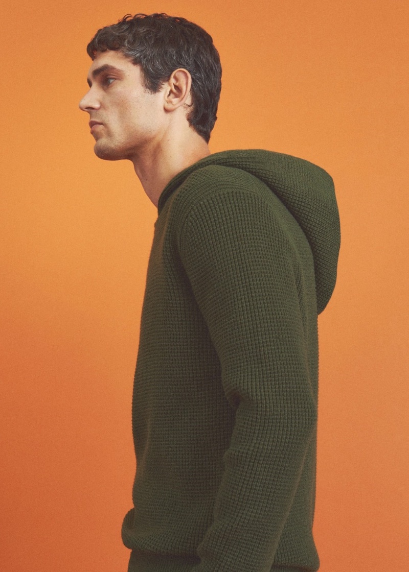 Perfect for layering, Arthur Gosse wears Mango Man's green structured hooded sweater.