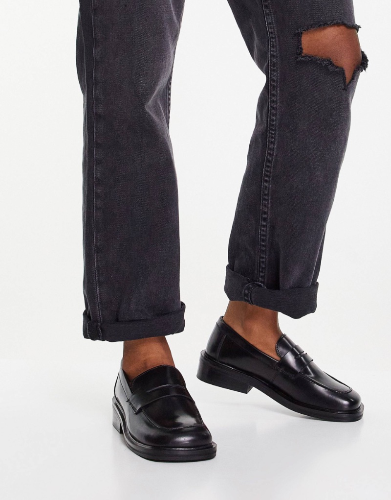 ASOS perfects the loafers without socks look with their black leather loafers and a pair of jeans.