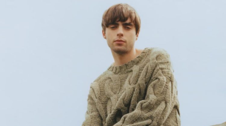 Model Lennon Gallagher wears a cable-knit sweater with jeans for Closed's winter 2022 campaign.