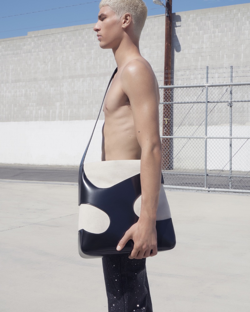 Ali Shaaban poses with a Ferragamo shoulder bag for the brand's spring-summer 2023 campaign.