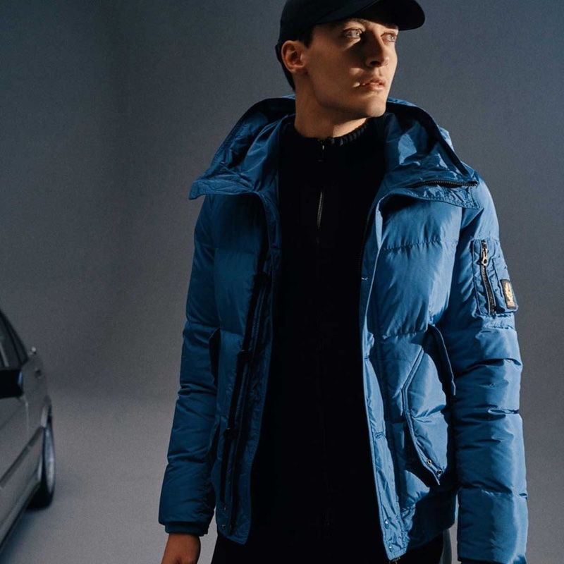 George Russell sports a blue quilted Belstaff jacket.