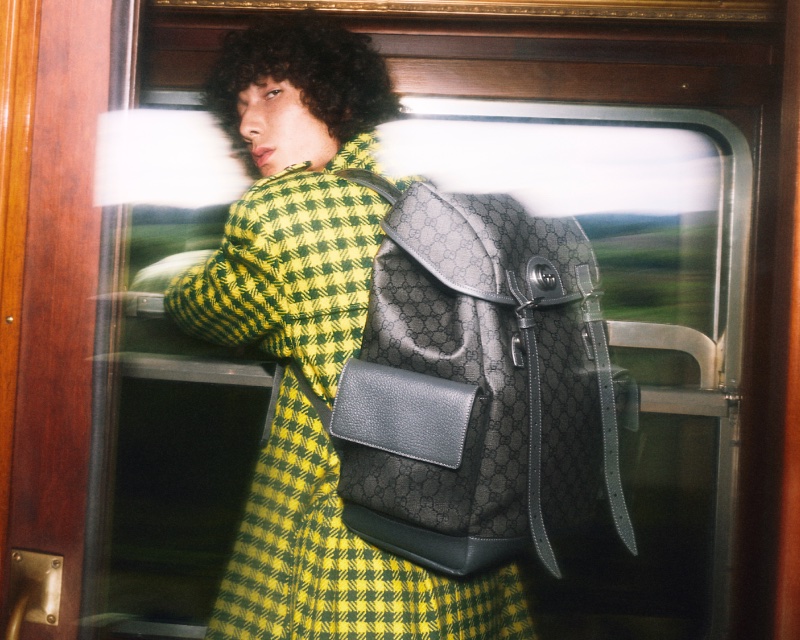Paul-Emile Paillier sports a houndstooth coat with a Gucci monogram backpack for the brand's Gift campaign.