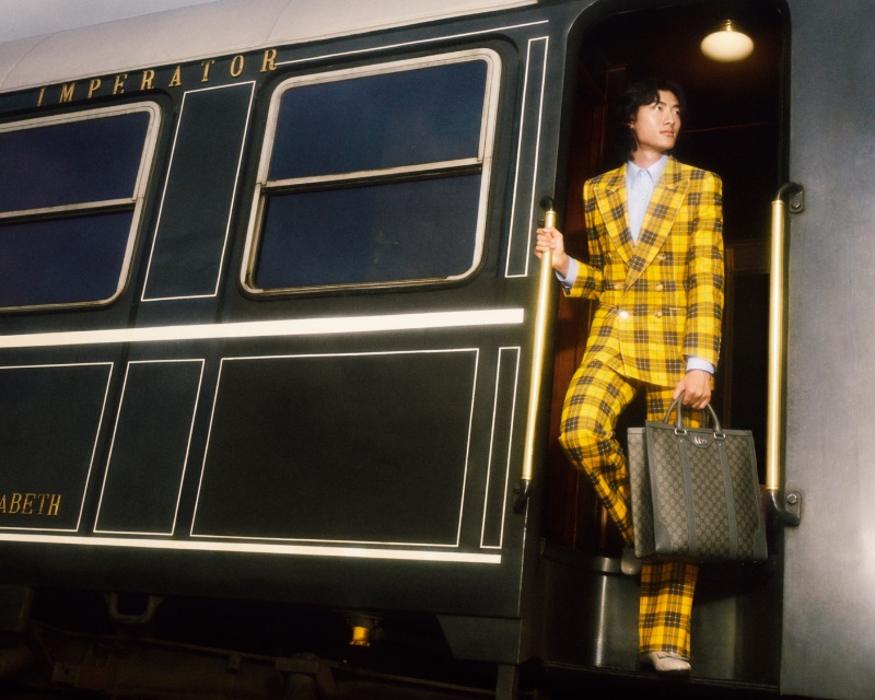 Model David Ge stands out in a double-breasted suit in yellow plaid for the Gucci Gift campaign.