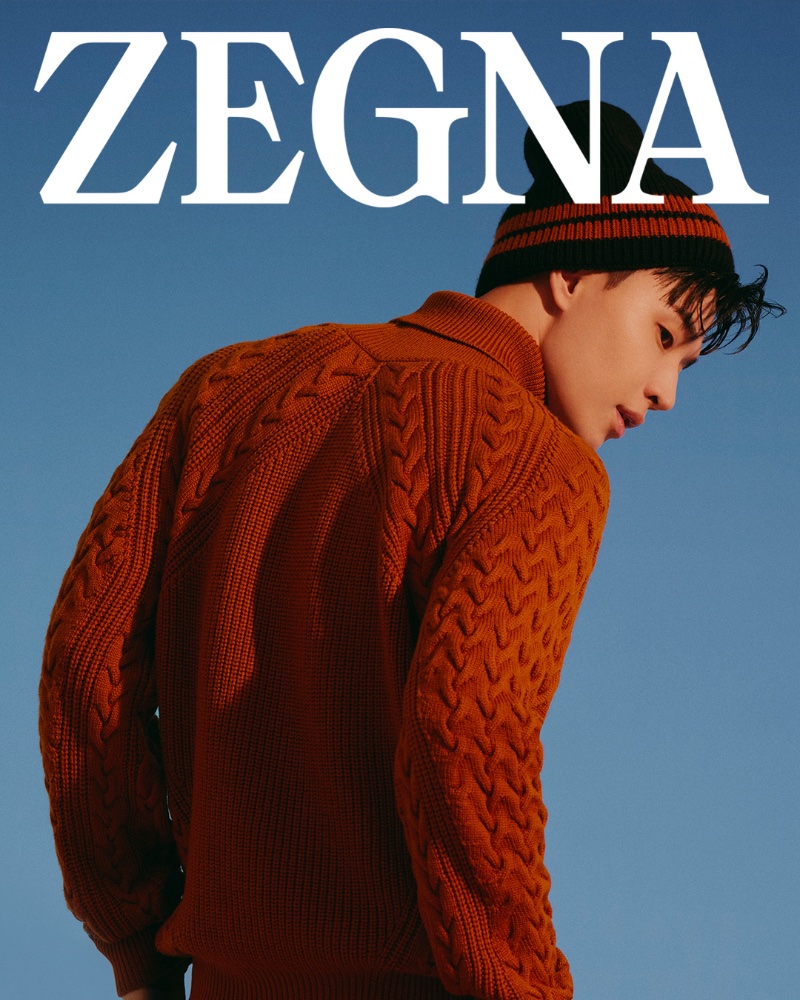 Henry Lau wears a cable-knit sweater and knit beanie for the Zegna Outdoor collection campaign.
