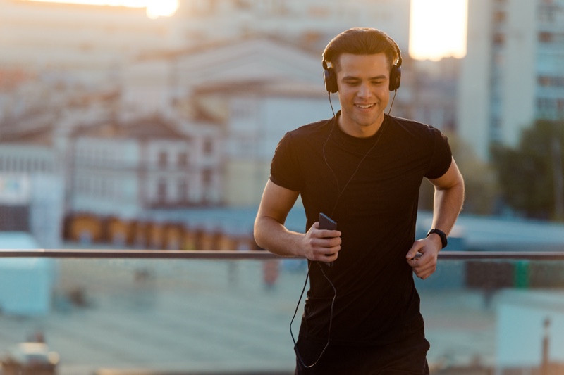 man jogging outdoors headphones