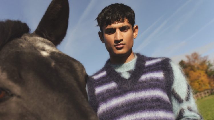 Neeraj Saini wears a striped mohair-blend sweater vest over an intarsia mohair-blend sweater from the Marni x Mytheresa capsule collection.