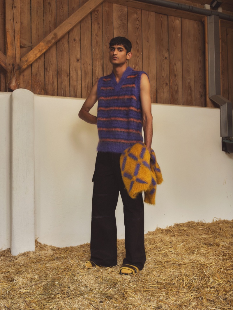 In front and center, Neeraj Saini showcases must-have sweaters from the Marni x Mytheresa capsule collection. The outing even includes striped slides!