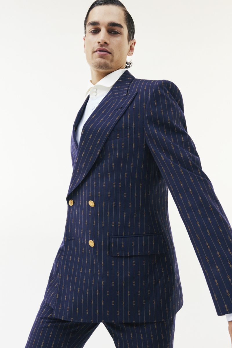 Manu Kumar, a dancer and model, wears a double-breasted Gucci suit for Mytheresa's holiday 2022 campaign.