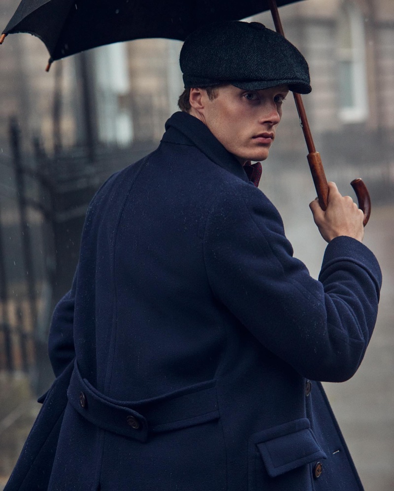 Hugh Laughton-Scott models a navy coat and a charcoal newsboy cap for the Polo Original Ralph Lauren fall-winter 2022 campaign.